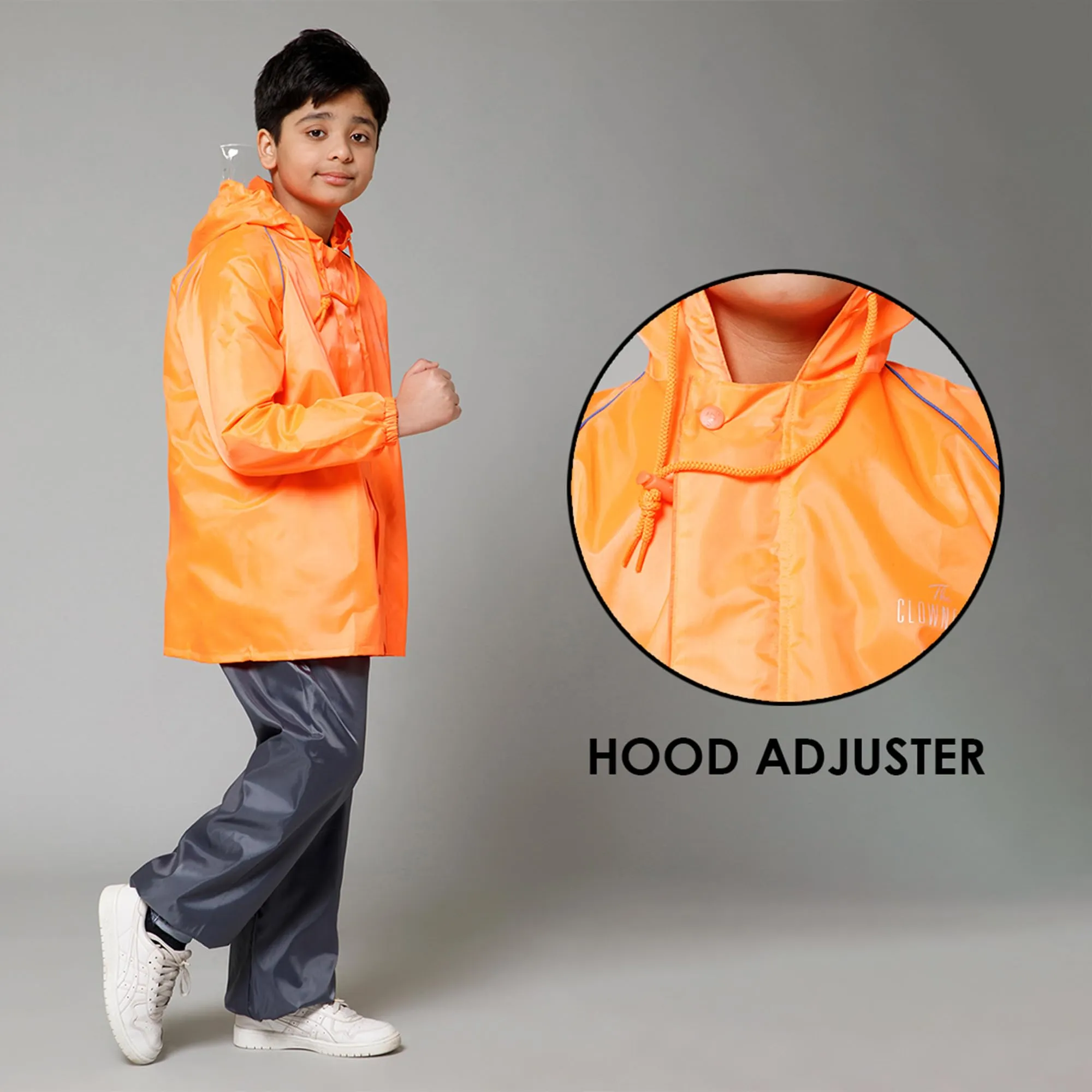 THE CLOWNFISH Duke Series Kids Waterproof Polyester Double Coating Reversible Raincoat with Hood and Reflector Logo at Back. Set of Top and Bottom. Printed Plastic Pouch. Kid Age-5-7 years (Orange)