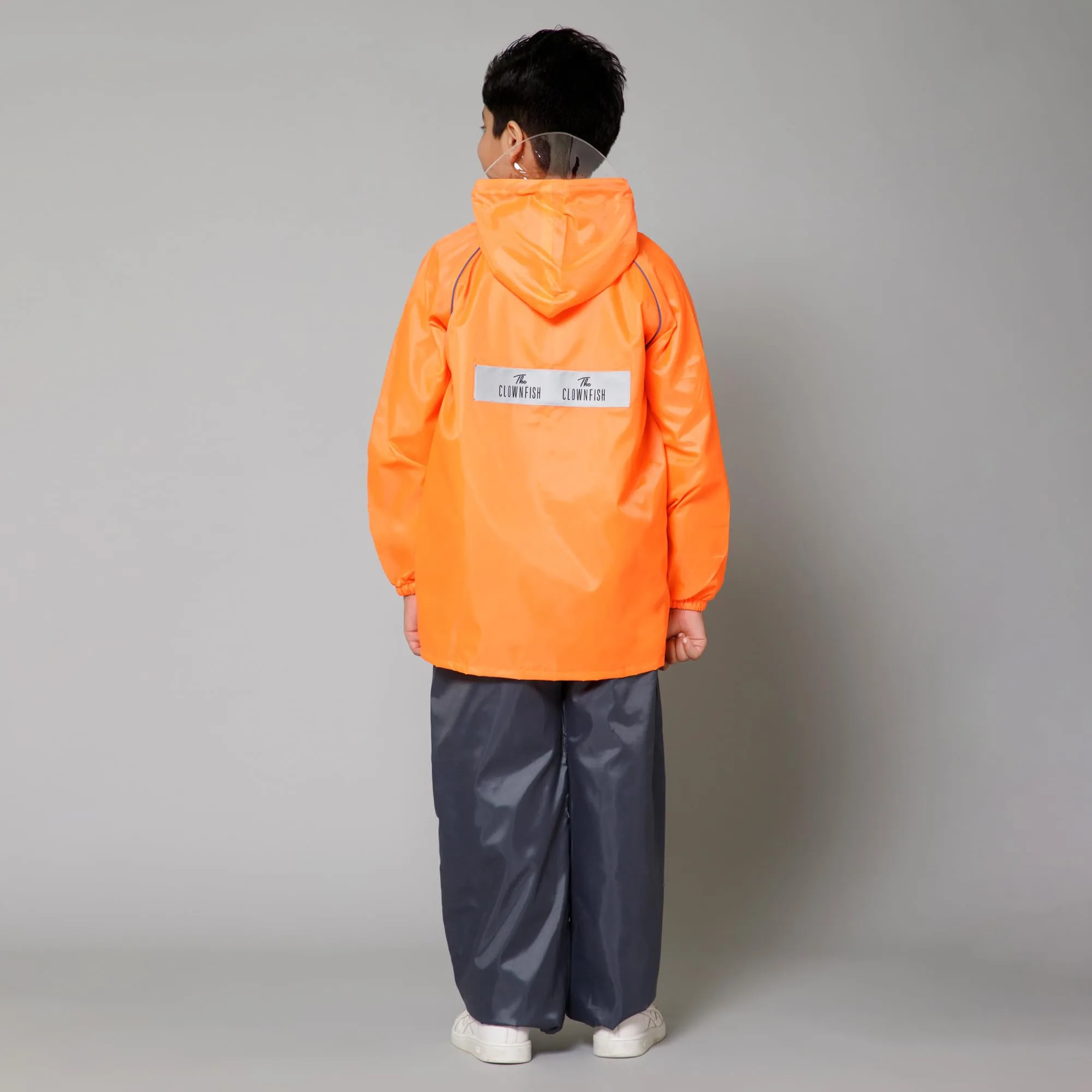 THE CLOWNFISH Duke Series Kids Waterproof Polyester Double Coating Reversible Raincoat with Hood and Reflector Logo at Back. Set of Top and Bottom. Printed Plastic Pouch. Kid Age-5-7 years (Orange)