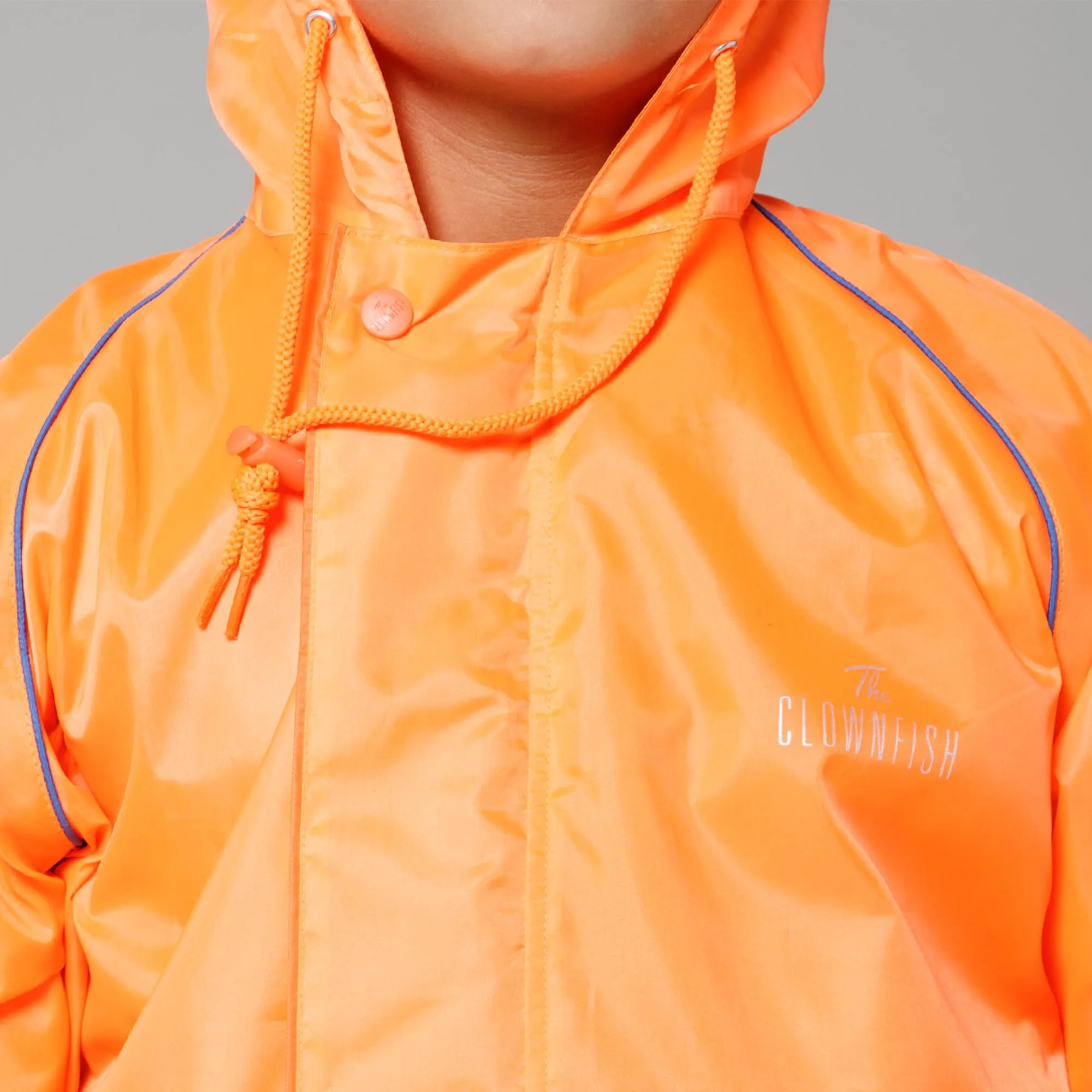 THE CLOWNFISH Duke Series Kids Waterproof Polyester Double Coating Reversible Raincoat with Hood and Reflector Logo at Back. Set of Top and Bottom. Printed Plastic Pouch. Kid Age-5-7 years (Orange)