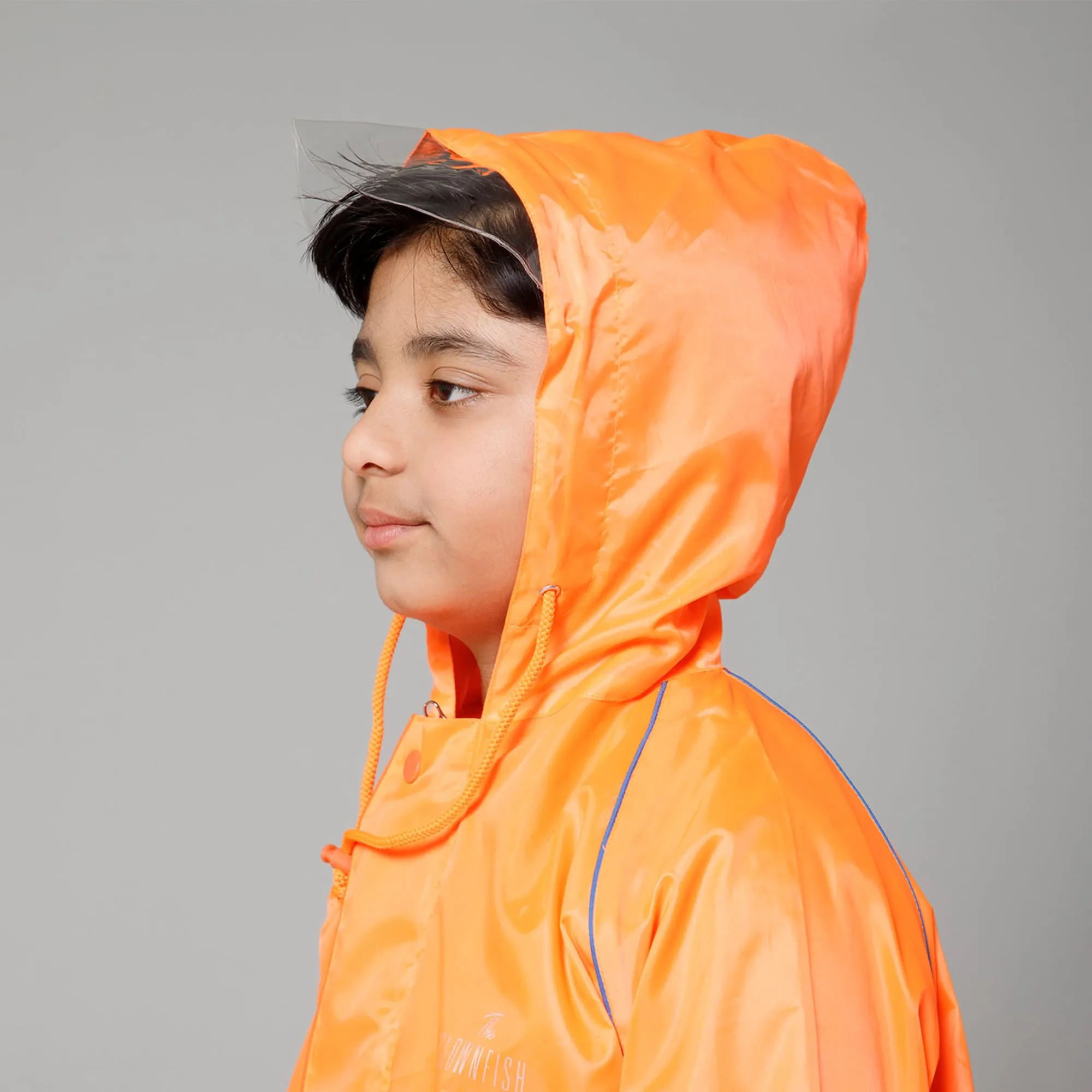 THE CLOWNFISH Duke Series Kids Waterproof Polyester Double Coating Reversible Raincoat with Hood and Reflector Logo at Back. Set of Top and Bottom. Printed Plastic Pouch. Kid Age-5-7 years (Orange)